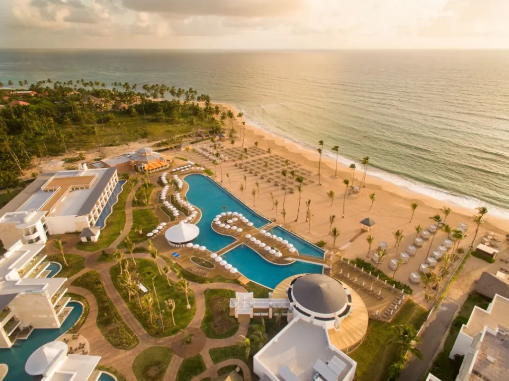 aerial view of white sand beach and large pools at beach palace in cancun