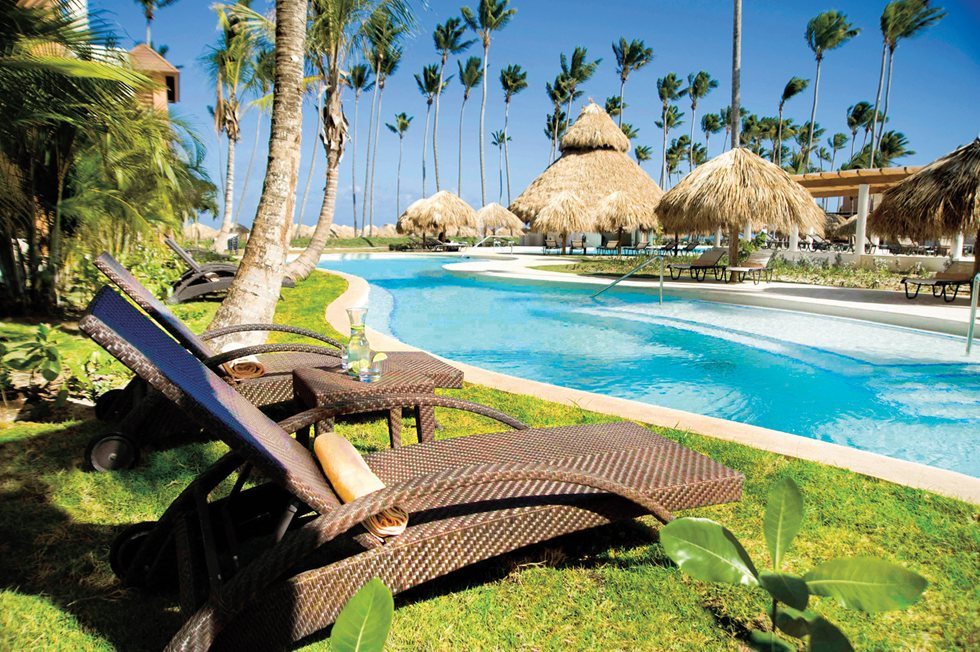 two sun chairs next to beautiful pool at Secrets Royal Beach