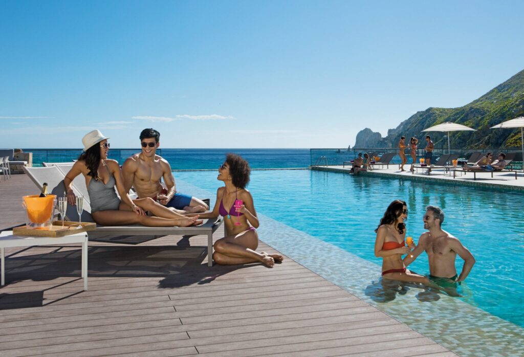 vacationers lounging in infinity pool at Breathless Cabo San Lucas resort