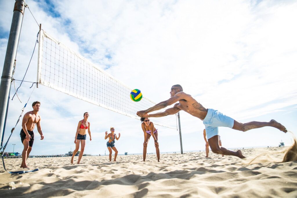 group playing beach volleyball