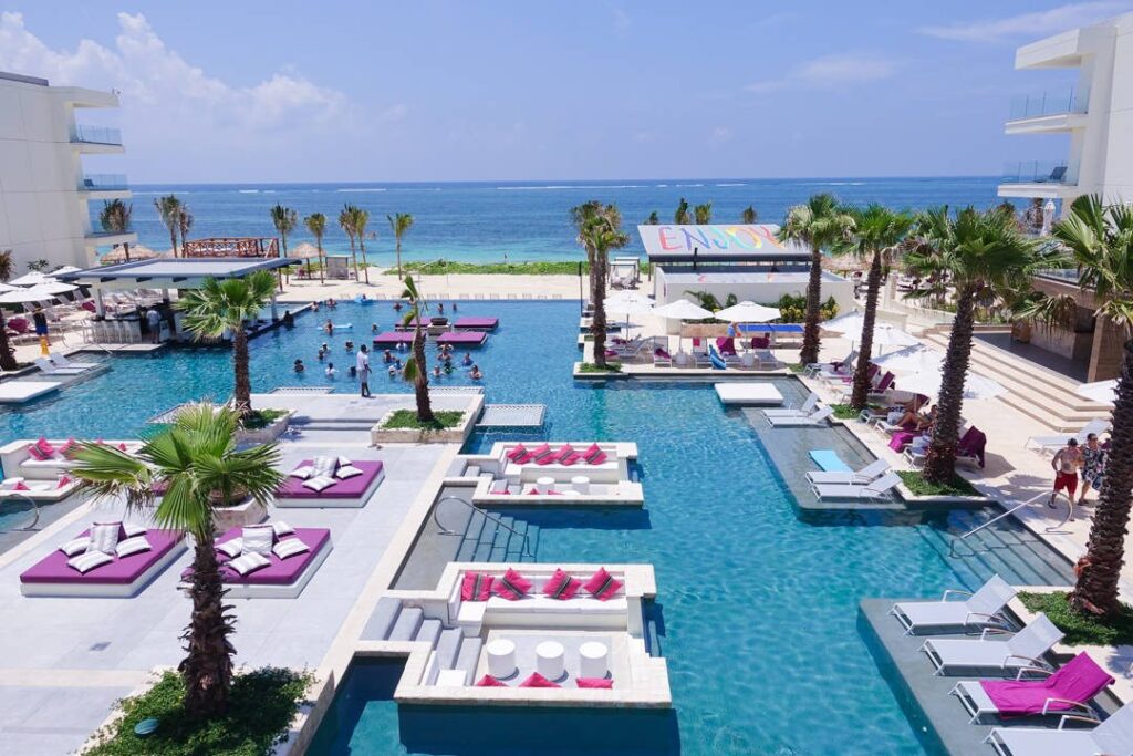 oceanfront pool surrounded by sun chairs and loungers