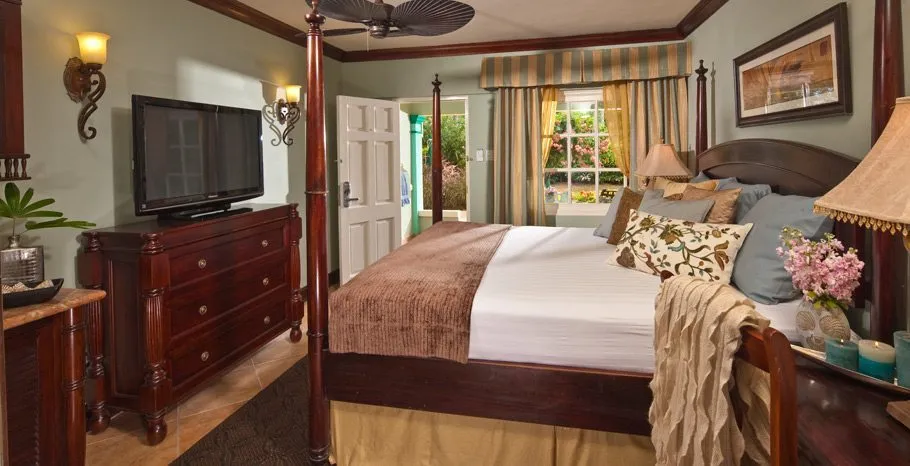 suite with four poster bed at Sandals Royal Caribbean