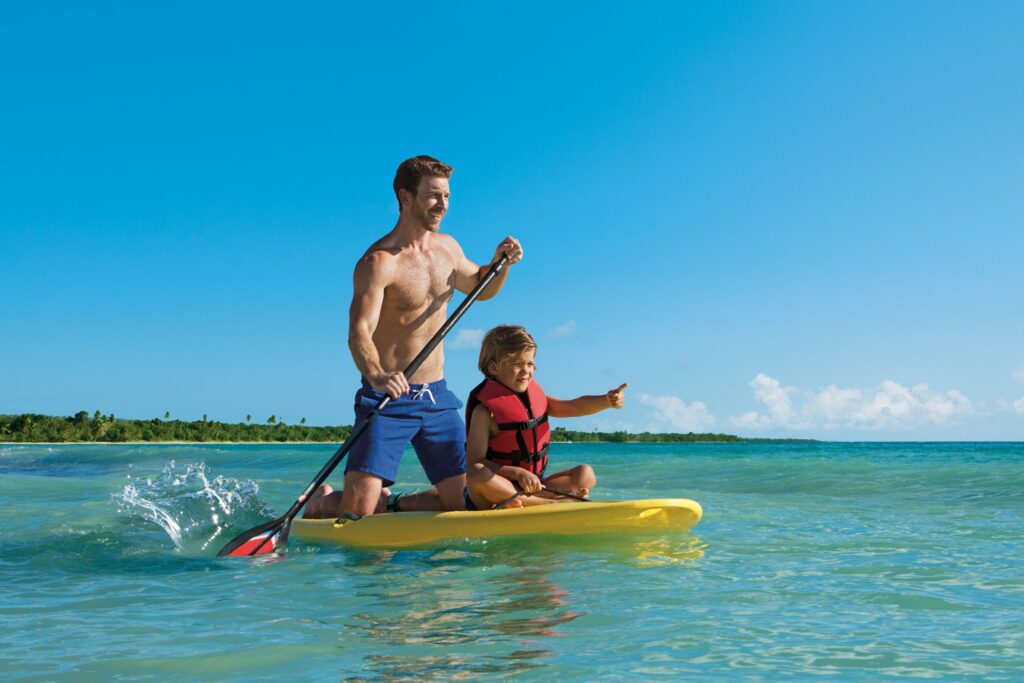 father and son paddle boarding