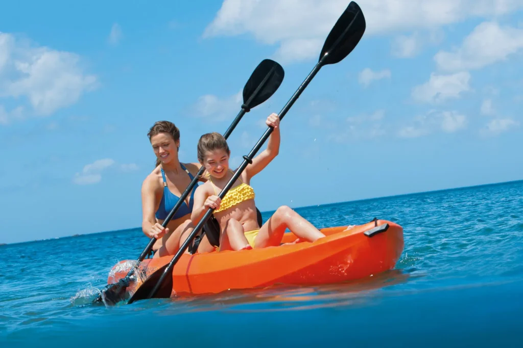 mother and daughter kayaking in ocean