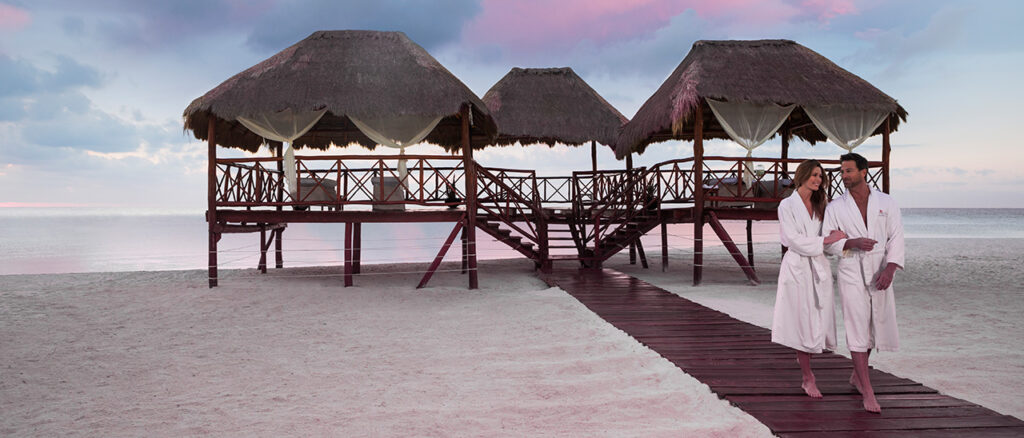 couple leaving massage on beach