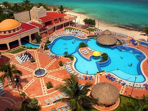 aerial view of large resort pool next to beach