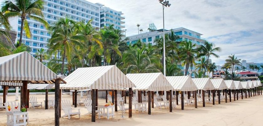 lounge chairs under canopies on beach