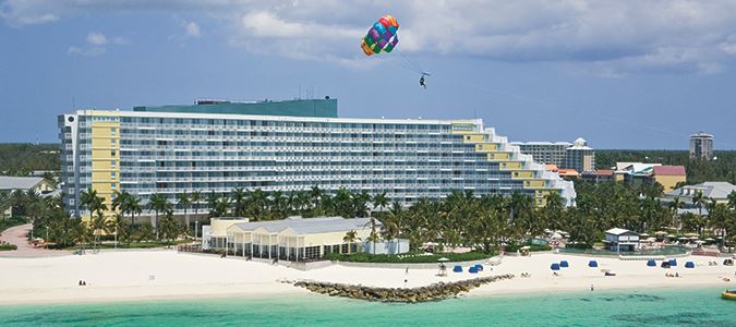 parasailing in front of beachfront resort