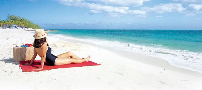 woman sunbathing on beautiful Bahamian beach