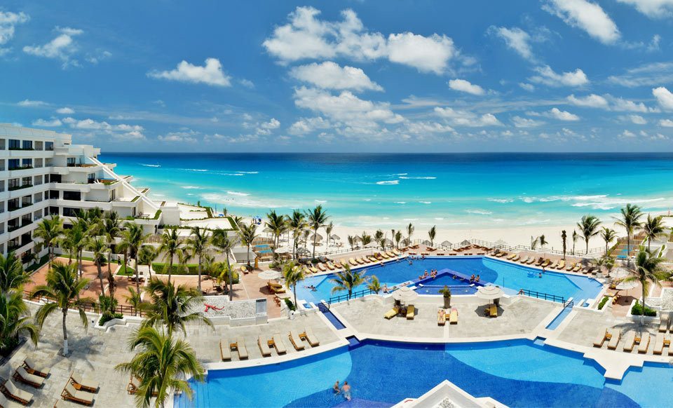 pool next to beautiful white sand beach