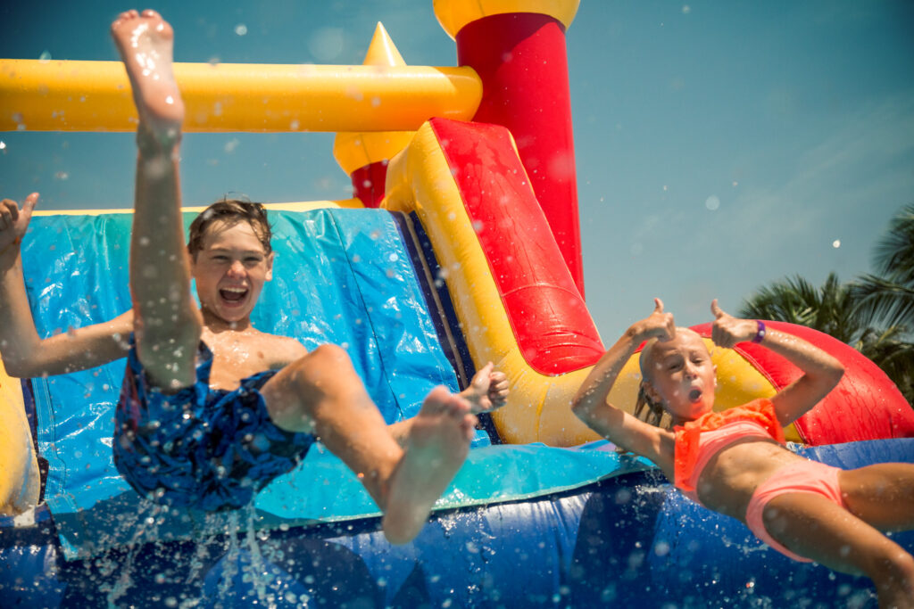 kids on inflatable water slide