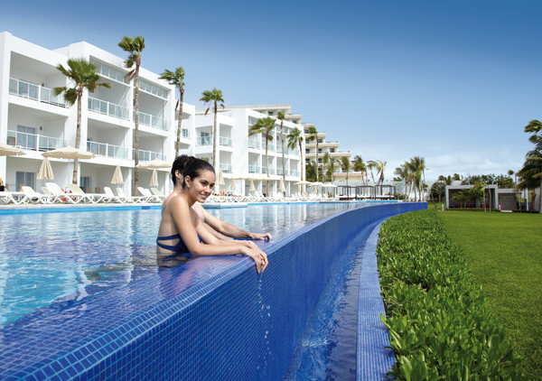 couple lounging in infinity pool