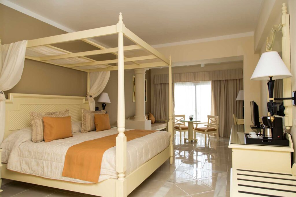 large suite featuring four poster bed and balcony
