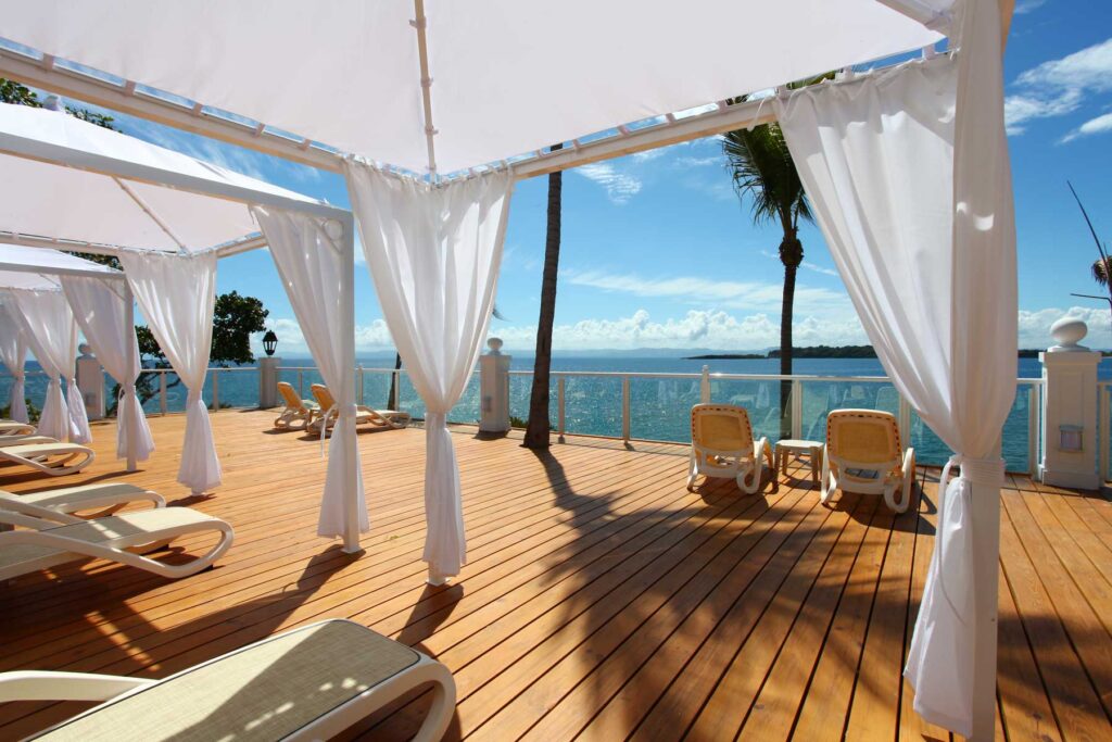canopies over lounge chairs on oceanfront deck