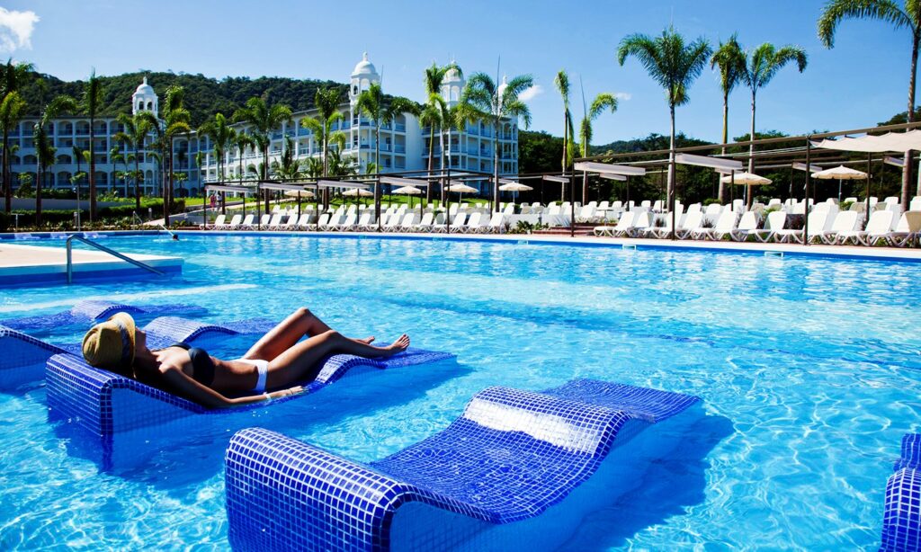 woman laying on lounge chair in pool