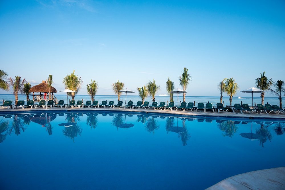 large pool overlooking white sand beach