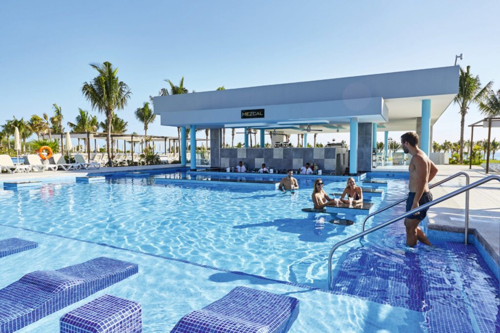 people lounging in the pool at swim up bar