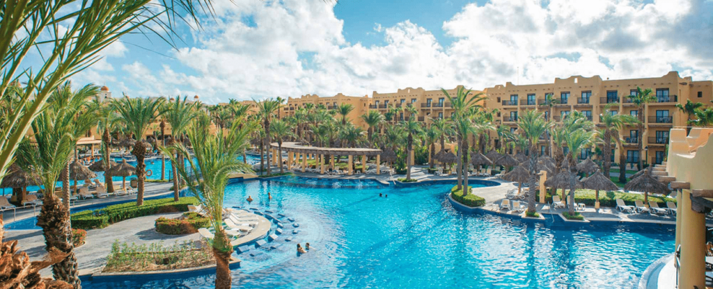 large resort  pool surrounded by  palm trees