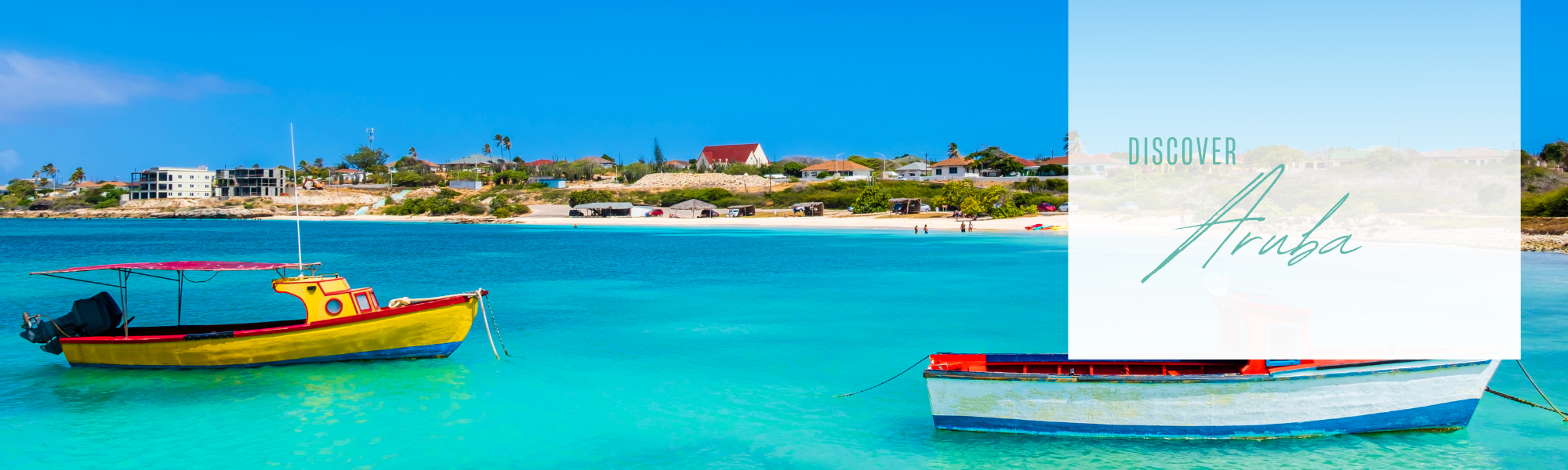 boats floating in blue ocean on Aruba beach