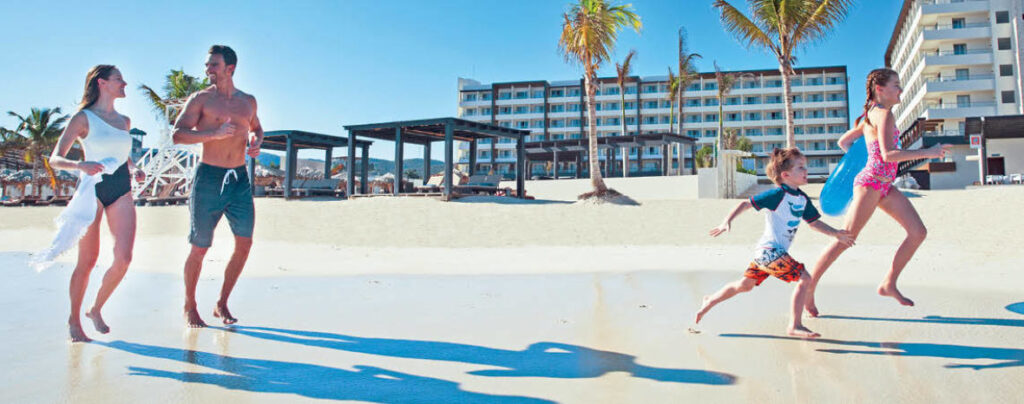 family playing on beach at Royalton Grenada Resort and Spa