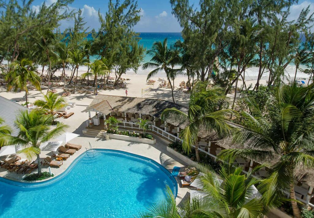 pool adjacent to beautiful white sand beach at Sandals Barbados