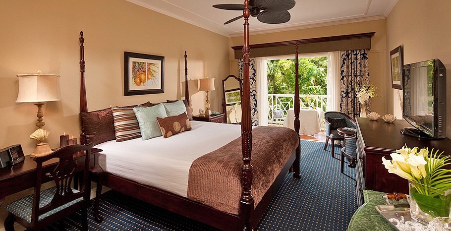 suite at Sandals Ochi featuring four poster bed and patio