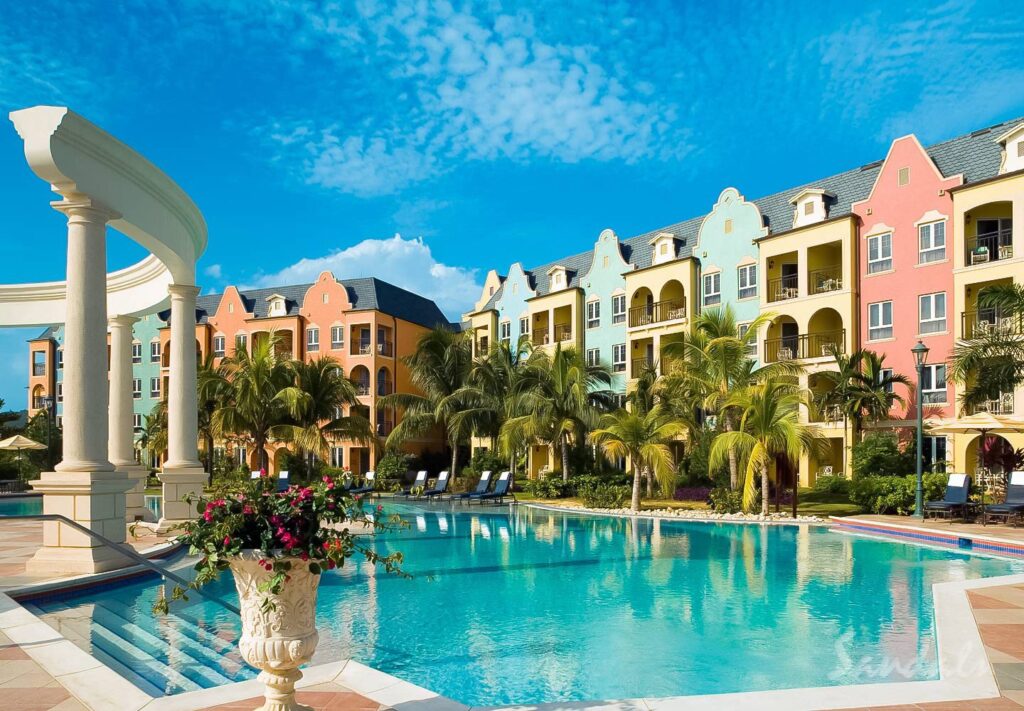 pool surrounded by resort rooms at Sandals South Coast