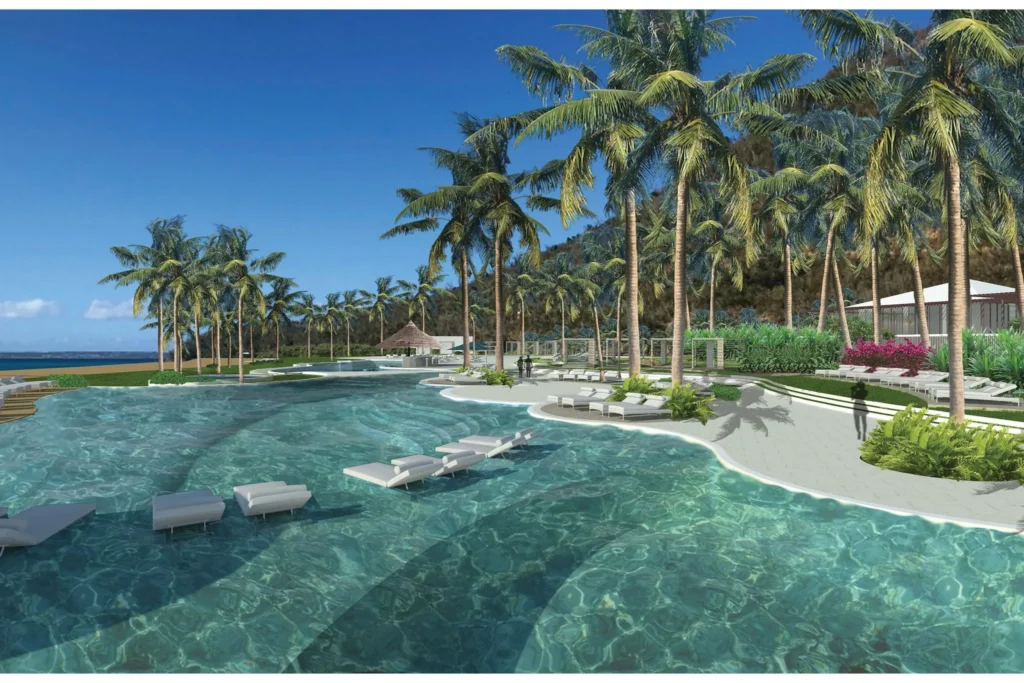 beautiful resort pool surrounded by palm trees at Secrets St. Martin