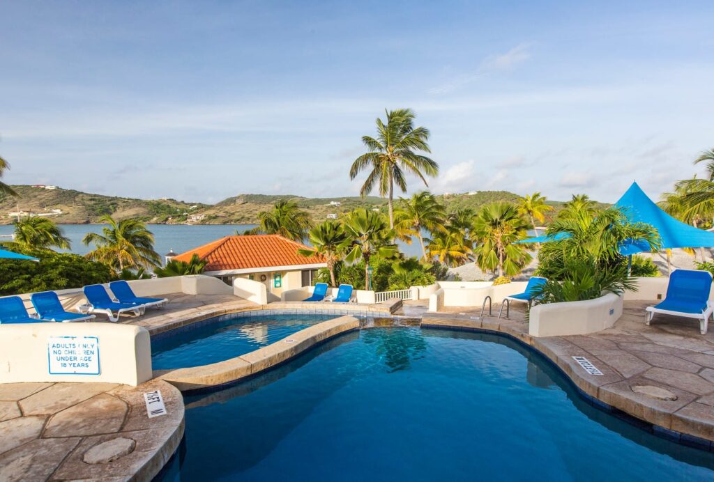 pool surrounded by palm trees at St. James Club and VIllas