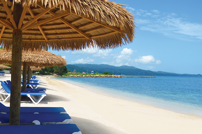 beach with mountains in the distance at Sunscape Cove Montego Bay