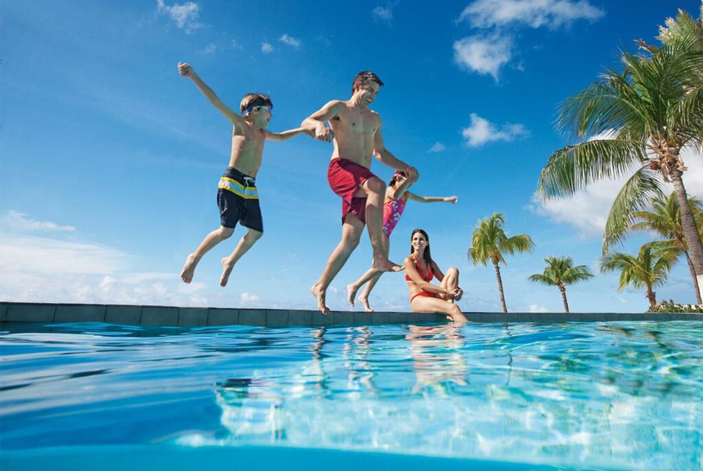 family playing in pool