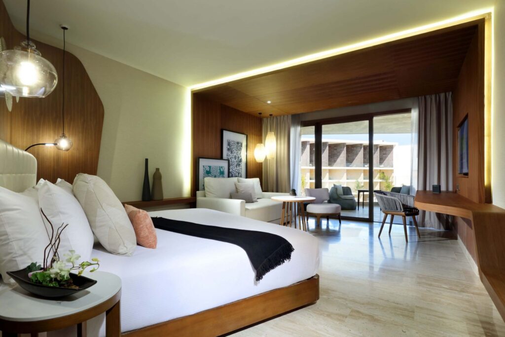large modern suite with balcony and living area at TRS Coral Hotel