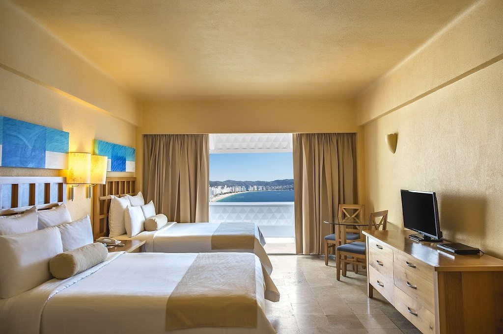 large resort room with double beds at Fiesta Americana Villas Acapulco