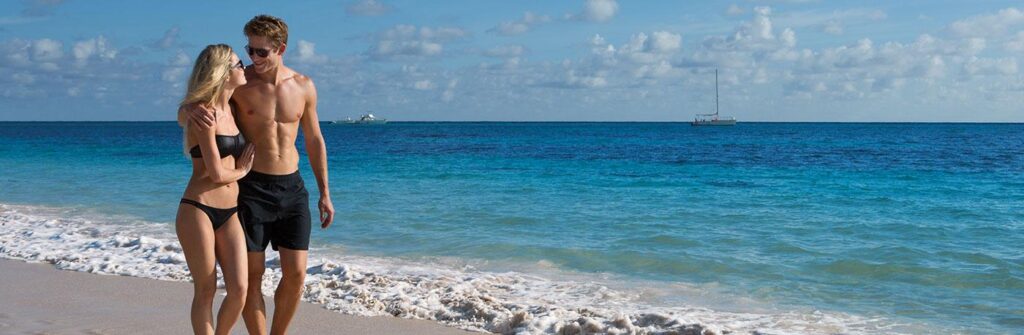 couple walking on beautiful white sand beach