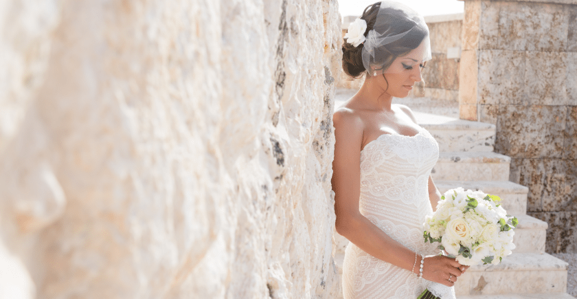 bride standing on stone stairwell