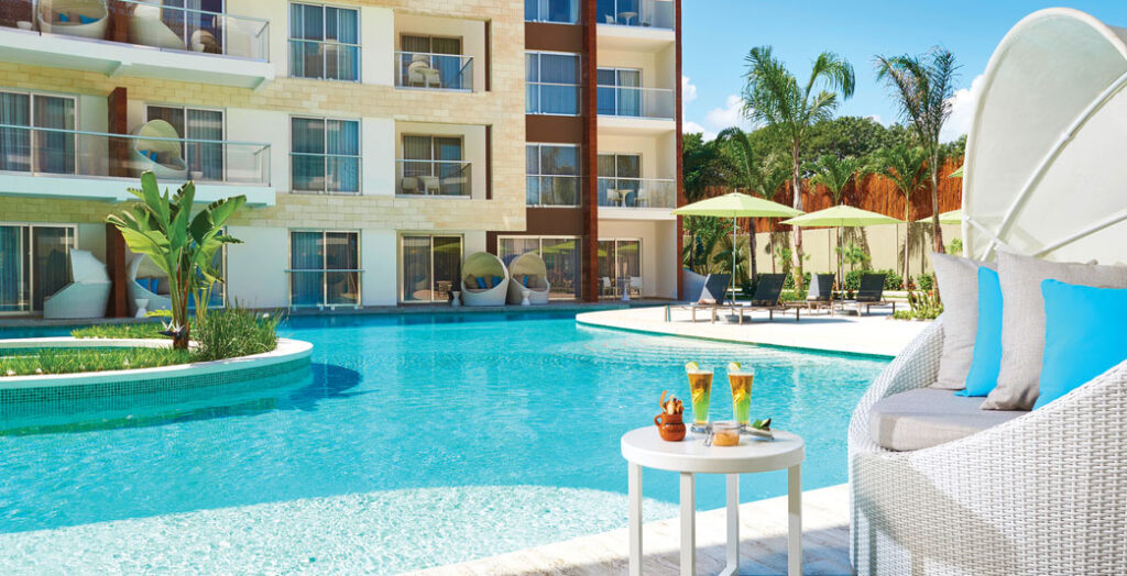 chair and tropical drinks next to resort pool