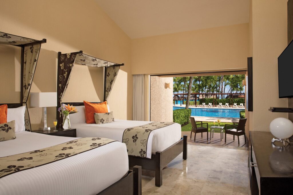 suite with two double beds adjacent to resort pool