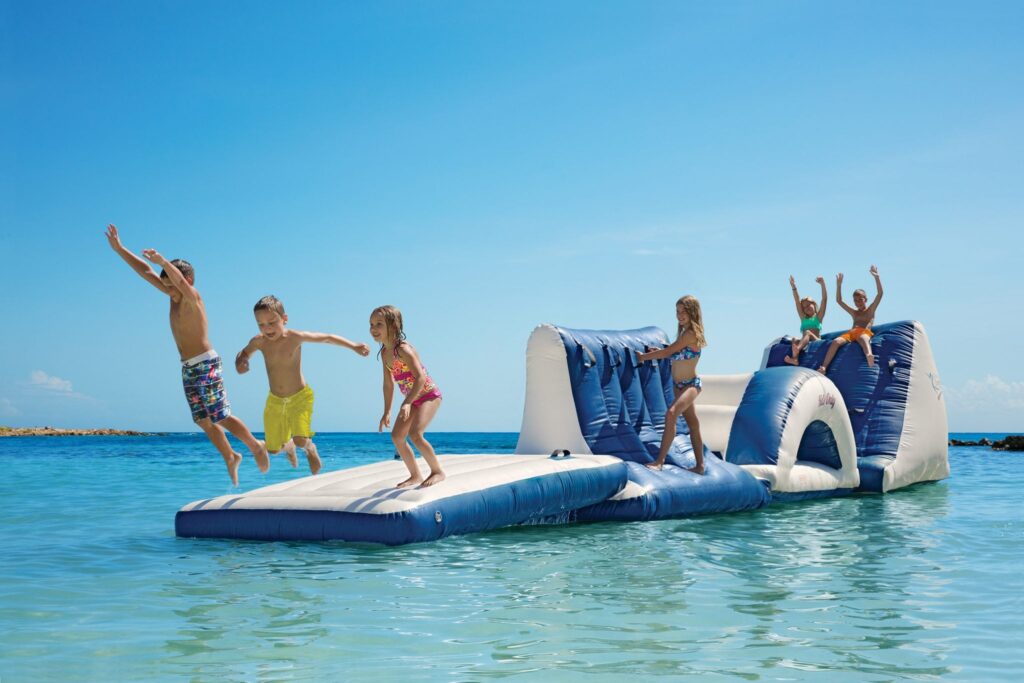 children playing on inflatable in the ocean