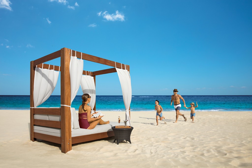 family playing on pristine beach at Dreams Riviera Cancun resort