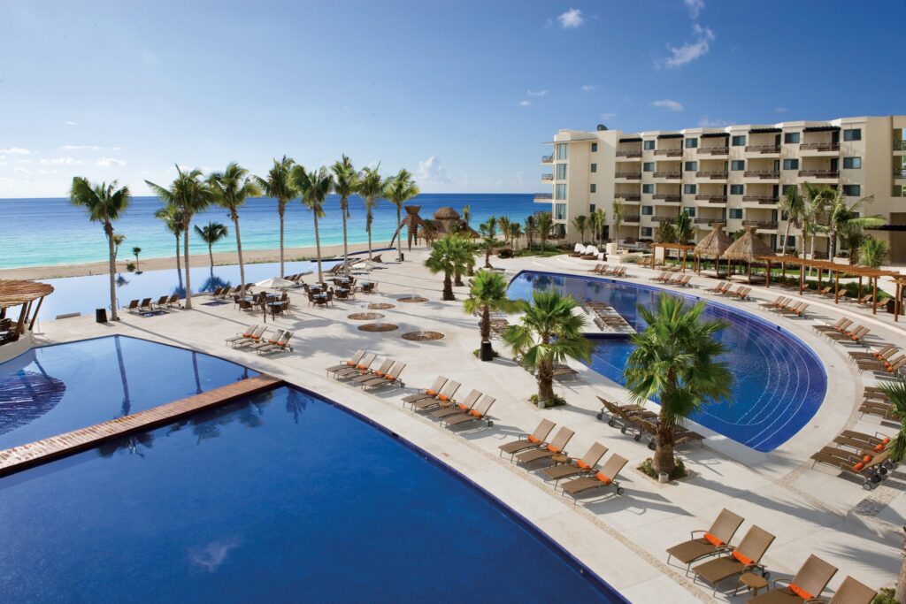 pools next to beautiful white sand beach in mexico