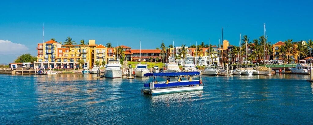 boats in front of Mediterranean style resort