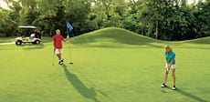 couple playing golf at Secrets Capri Riviera Cancun