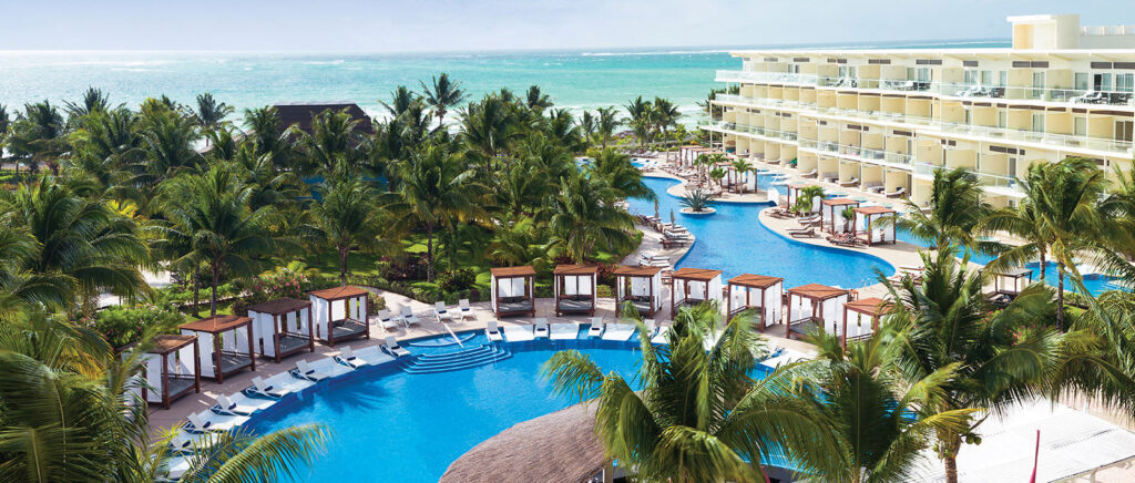 aerial view of Azul Beach Resort Sensatori featuring beach, resort suites, and multiple pools