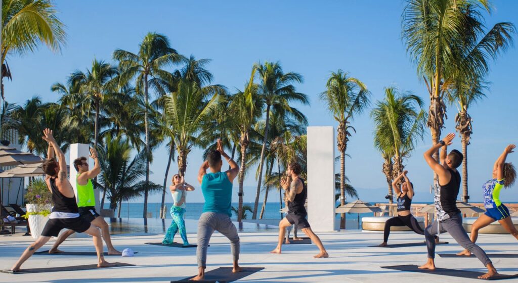 group yoga class on beach