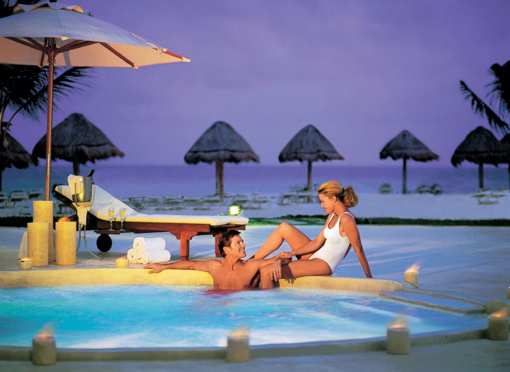 couple lounging in jacuzzi at night