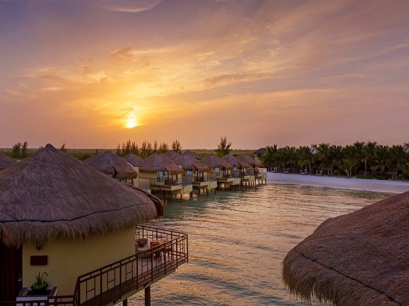 overwater bungalows at sunset