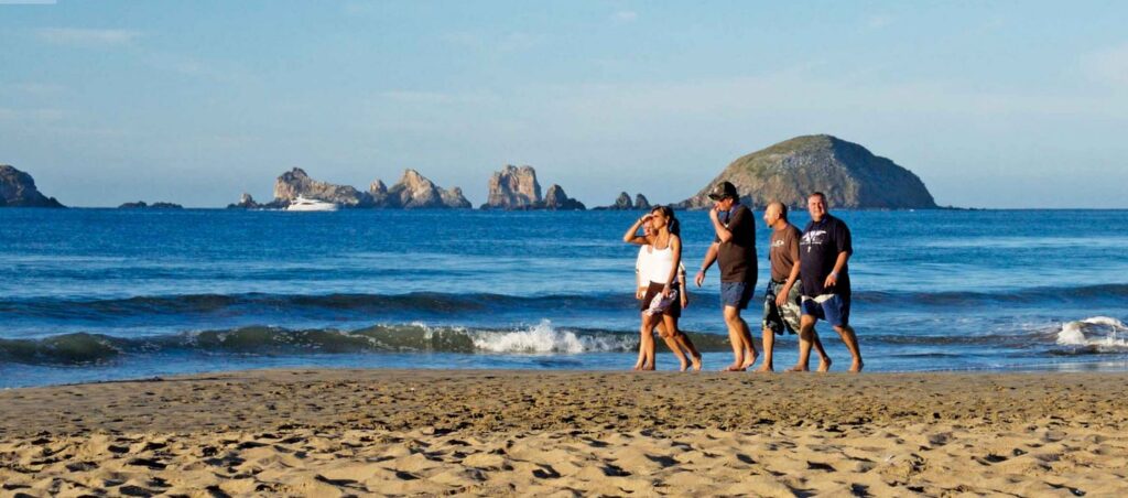 Friends walking on beach