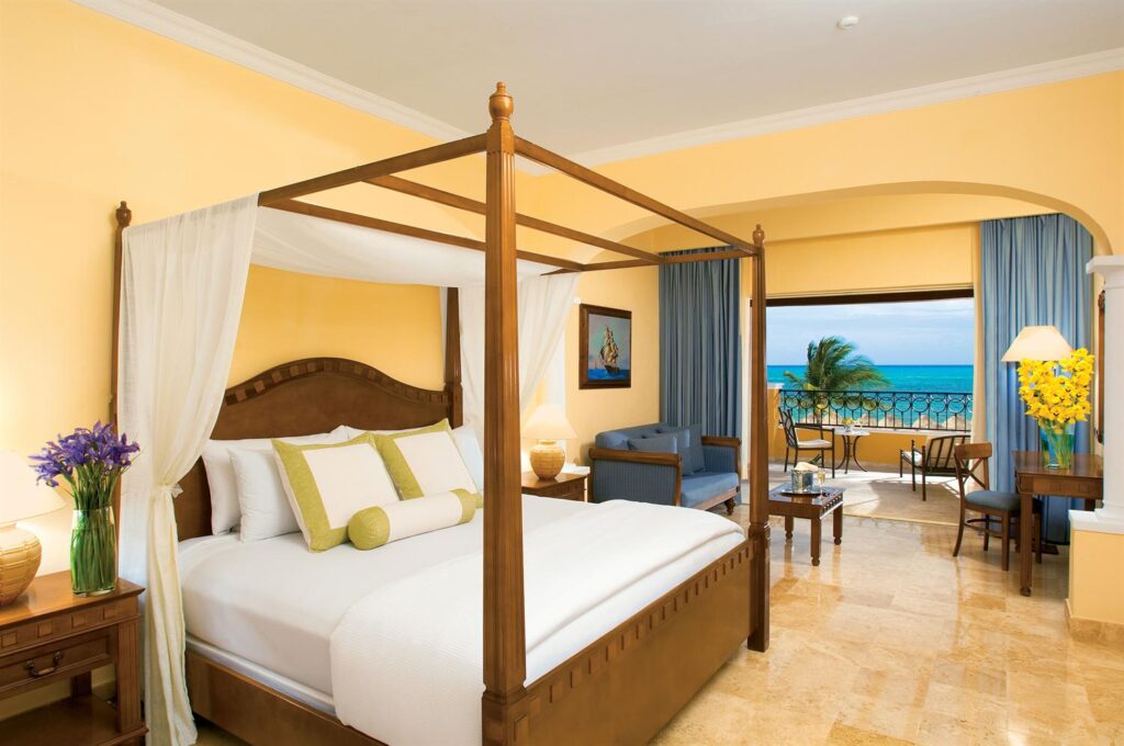 Secrets Capri Riviera Cancun suite with four poster bed and large ocean front balcony