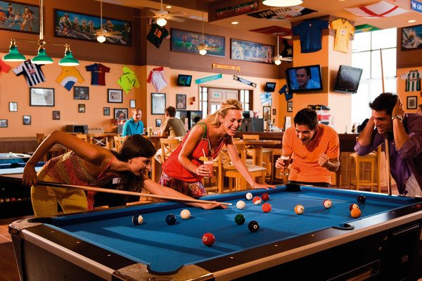 group playing pool in bar area