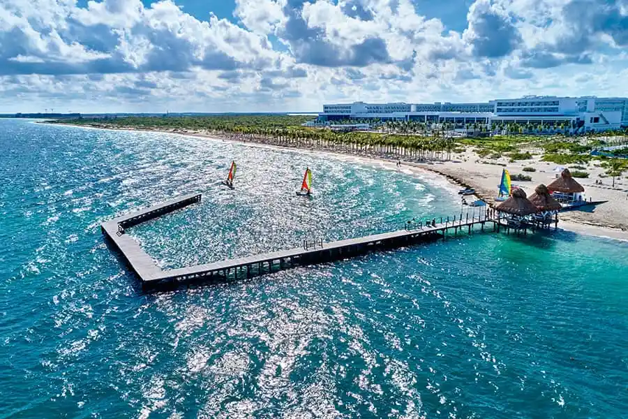 large pier over turquiose waters at Hotel Riu Palace Costa Mujeres